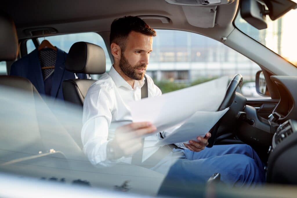 manager man working on paperwork in the car